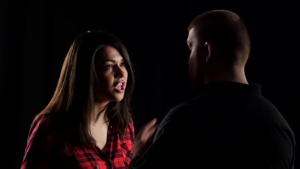 Close-up of Woman Arguing with Her Boyfriend on Black Background alt