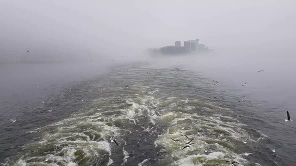 View of the Waves Following the Ship in Foggy weather.View of a Floating Motor Boat.