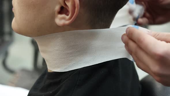 barbershop. barber is preparing male client for the haircut. mens beauty salon. Client man sitting 