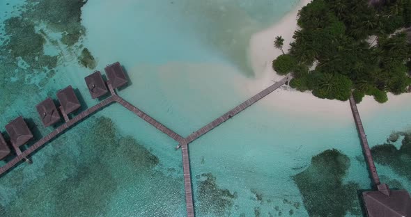 Aerial 4K view of water bungalow on a Maldives island resort