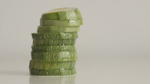 Round slices of Pepo cylindrica 4K 2160p 30fps UltraHD tilting footage - Cuts of zucchini on pile sl alt