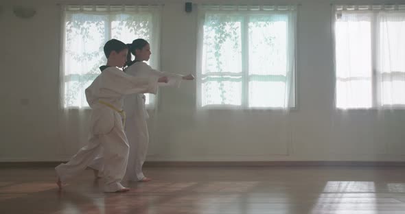 Slow motion footage of young kids practicing martial arts alt