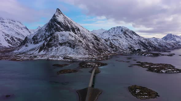 Fredvang Bridge and Volandstind Mountain in Winter. Lofoten, Norway. Aerial View alt
