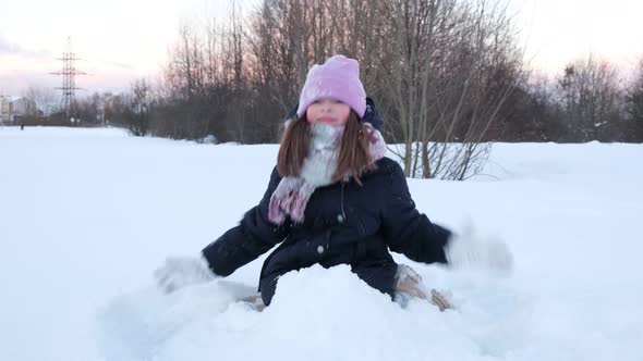 Little Cute Girl Playing with Snow Having Fun