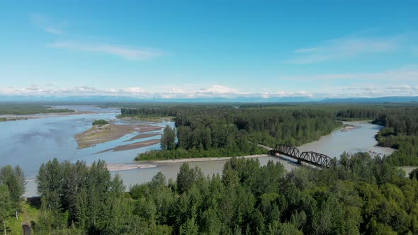 4K Drone Video of Alaska Railroad Train Trestle with Mt. Denali in Distance during Summer alt