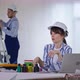 Woman in Safety Helmet Due To Trouble New Interior Design at Construction Site Sitting at Laptop and
