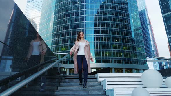 Slim Girl with Long Hair Quickly Descends Stairs alt
