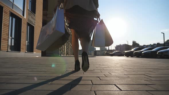 Female Feet in Black Shoes on High Heels Stepping at Sidewalk alt