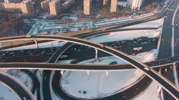 Complex Road Junction and Cars Traffic at Sunny Winter Evening in City. Aerial View alt