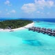 Aerial Shot Of Luxurious Water Bungalows On Turquoise Sea Drone Flying Forward Over Resort On Sunny - VideoHive Item for Sale
