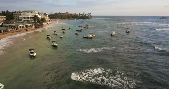 Colorful Boats on Sea Waves Near Sand Coastline of Town