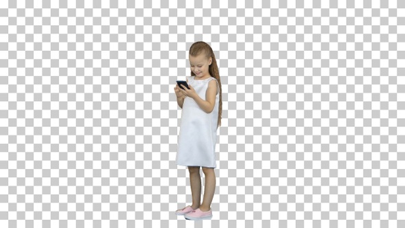 Cute little girl smiling and uses a mobile phone, Alpha Channel
