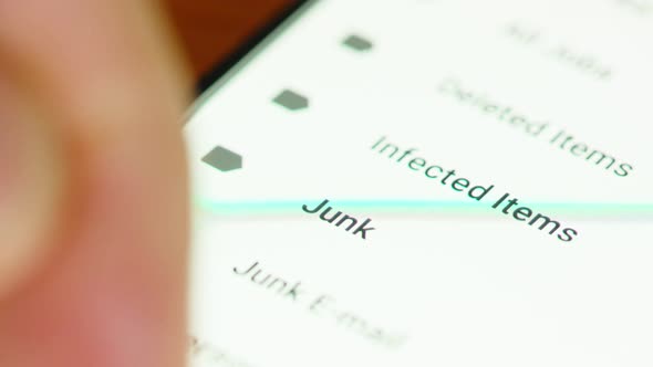 close up of hand browsing through mail folders a smartphone screen alt