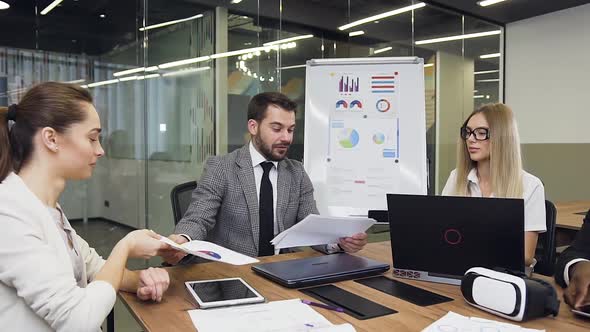 Businessman Transmitting for Familiarization Different Reports with Graphs alt