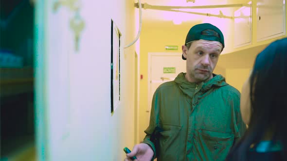 Electrician Opens Fuse Box Board and Starts Removing Screws alt