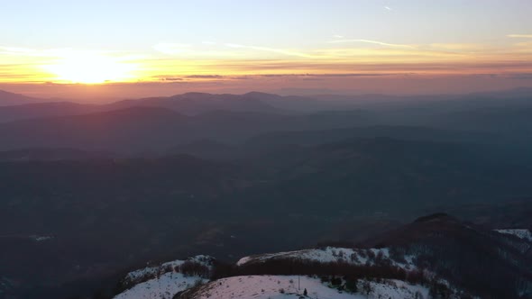 Aerial view at the mountain on a sunset of the winter day