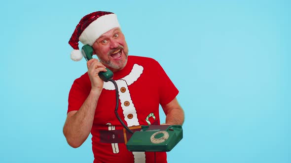 Funny Man in Christmas Tshirt Talking on Wired Vintage Telephone of 80s Says Hey you Call Me Back alt