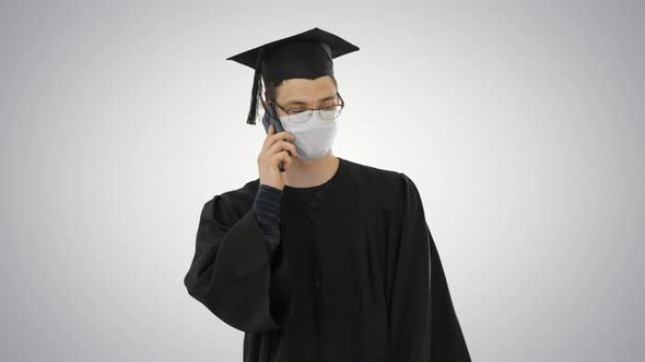 Young Graduate Student Making a Call with Smartphone with Medical Mask on on Gradient Background alt