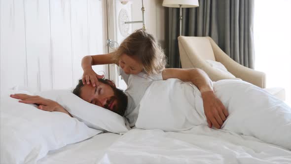 Daughter Comes To Sleeping Father and Opens His Eyes By Hands for Wakes Him alt