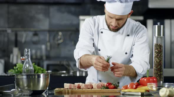 Male Chef Seasoning Meat in Slow Motion. Portrait of Cook Seasoning ...