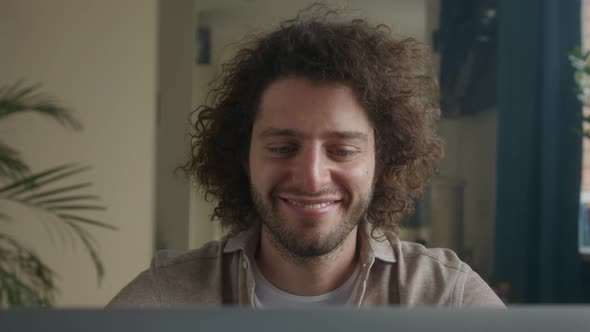 Man at Home at the Computer Looking for a Solution Good News Smile alt