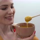 Smiling Young Woman with Bowl of Honey on White Background - VideoHive Item for Sale