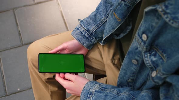 View From Shoulder of Caucasian Man Watching Chroma Key of Modern Smartphone alt
