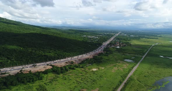 Aerial view country road in forest alt