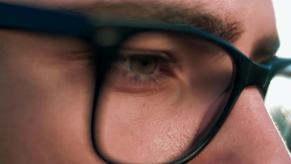 Close-up of a focused look of a young man in glasses for vision	 alt