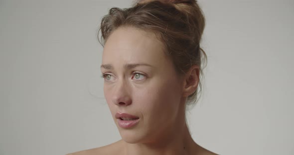 Beautiful Young Woman Crying And Wiping Tear Away alt