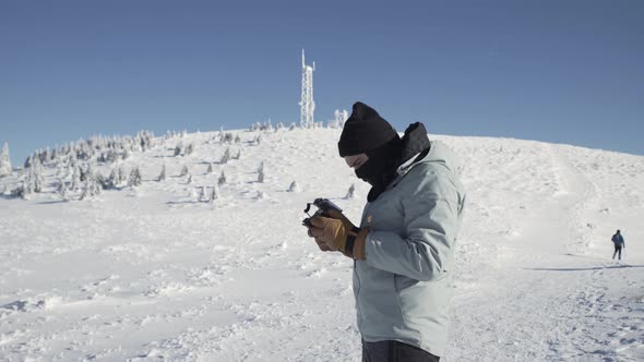 Photographer Using Drone Remote During Winter Season