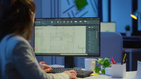 Over the Shoulder Shot of Engineer Working with Architectural Plans alt