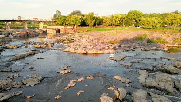 Panoramic view of Falls Park on a bright sunny day with beautifully landscaped park.