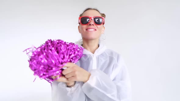 A Joyful Female with Red Glasses Dancing with Pompoms on a White Background alt