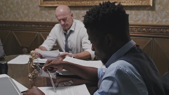 Tired African American Lawyer Working with Document alt