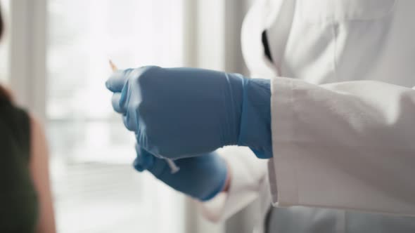 Pregnant caucasian woman sitting with protective mask after vaccination. Shot with RED helium camera alt