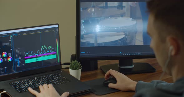 Man Working on Computer with Two Monitors Video Editing. Monitor the Computer and Capture the Work