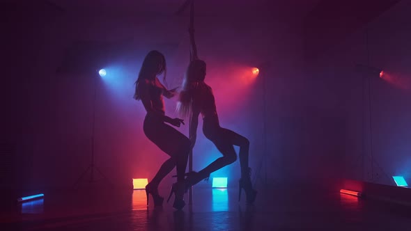 Dancers in Dark Studio with Pole at Blue and Red Smoke. Beautiful Dancing Girls alt