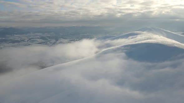 Fly Through the Clouds Over the Mountain Peaks