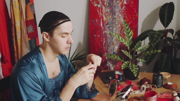 Transgender Man Applying Mascara alt