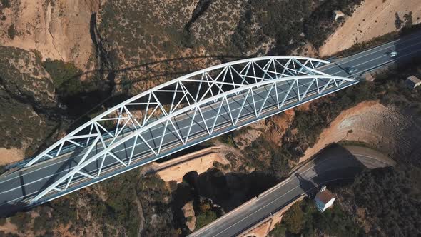 Aerial view of a modern bridge on top of another two older bridges from different periods. Older one alt
