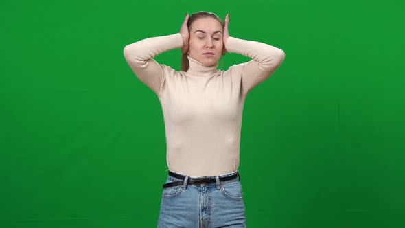 Irritated Woman Closing Ears with Hands Shaking Head No alt