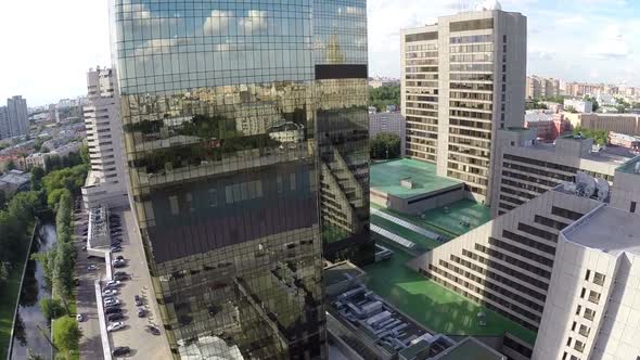 Airplane view on city reflection in mirror facade of building alt