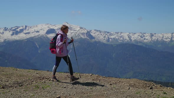 Backpacking in Mountains Woman with Backpack is Hiking at Top of Mount alt