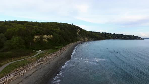 Wide aerial showing the wide coastline of Discovery Park in Seattle, Washingon. alt