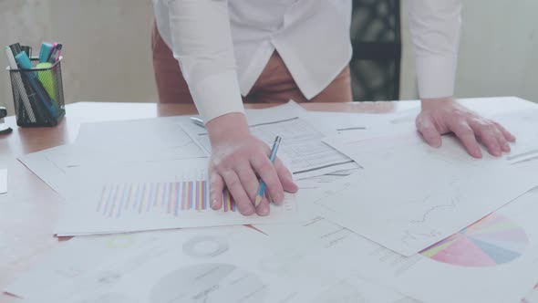 Businessman working with charts in the office at the table alt