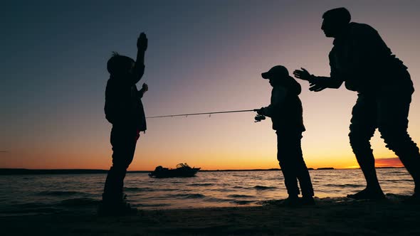 Kids and Their Dad Are Being Happy While Fishing at Sunset alt