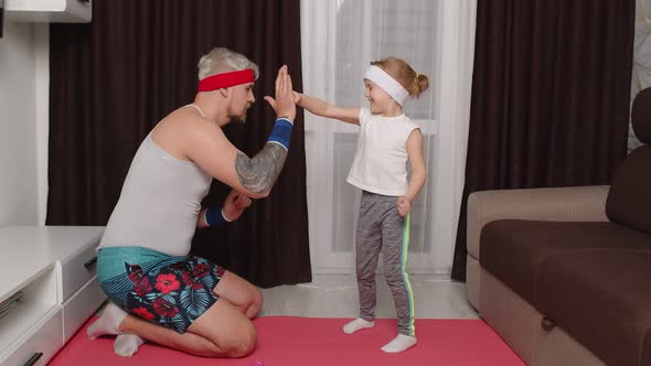 Sportsman Man Coach Working Out with Child Kid Girl Boxing Exercises with Daughter at Home on Mat alt