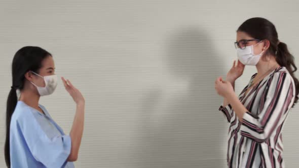 Happy Friends Take Off Face Mask and Hug Each Other Closely Together alt