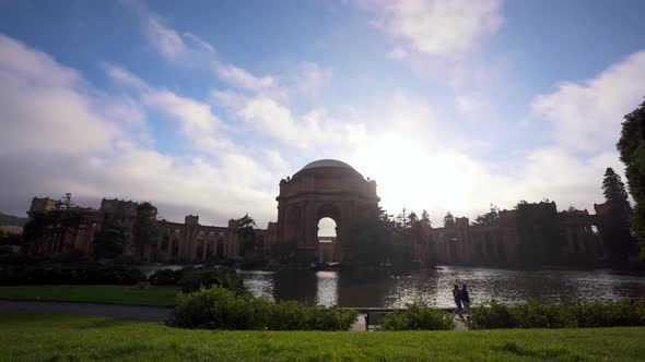 The Palace of Fine Arts, cloudsing fast and people walking by the lake alt